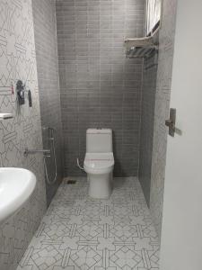 ein Badezimmer mit Toilette und Waschbecken in der Unterkunft Hotel Lynx in Kumbakonam