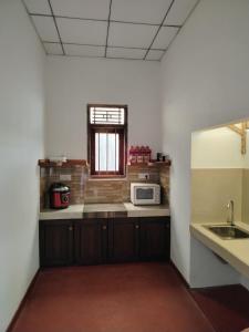 a kitchen with a sink and a microwave at Bobbys Villa Mirissa Walk to Mirissa Beach in Mirissa +41 photos