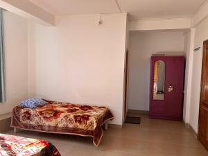 Postel nebo postele na pokoji v ubytování Woods Homestay