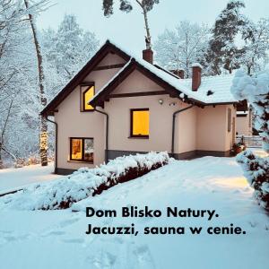 a house covered in snow with the words dont bikers nirvana karma karma at Dom Blisko Natury Boszkowo Letnisko Dom A in Boszkowo-Letnisko