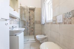 a bathroom with a toilet and a sink and a shower at Villa Serenella in Carovigno +33 photos