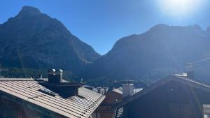 a view of a city with mountains in the background at Casa Auroranna in Sappada +3 photos
