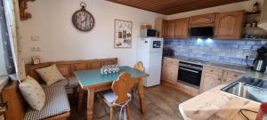 a kitchen with a small table and a counter top at Time Out Moments Haus mit eigener Sauna in Grafenau