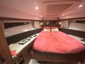 un lit au milieu d'une petite pièce dans l'établissement luxueux bateau à quai, à Sari-Solenzara