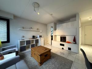 a living room with a couch and a table at Nordic Nest B in Vantaa