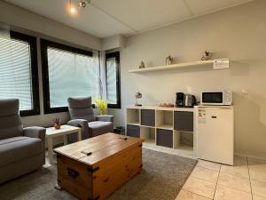 a living room with a refrigerator and a table at Nordic Nest B in Vantaa