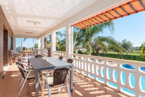 a patio with a table and chairs on a balcony at Masia Miliuca Paraíso rural a un paso de Valencia - Rural paradise close to Valencia in Bétera