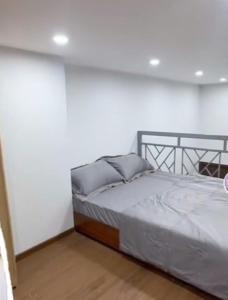 a bedroom with a bed in a white wall at 1988 Homestay in Phu Quoc