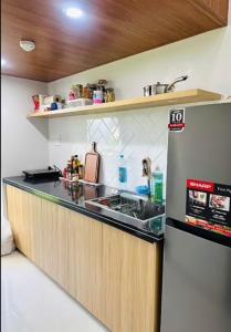 a small kitchen with a sink and a refrigerator at 1988 Homestay in Phu Quoc