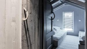 a door to a room with a bed and a window at Simple Cabin Life In This Nature Cabin in Uvdal