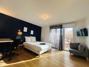 a bedroom with a bed and a desk and a window at Casa Grand Groupe in Sorges +22 photos