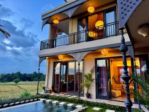 a house with a swimming pool in front of it at Theatrical 4bd Villa Escapades with epic Rice Terraces Panoramas in Cemagi