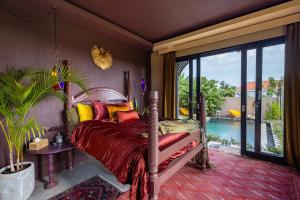 a bedroom with a bed and a large window at Theatrical 4bd Villa Escapades with epic Rice Terraces Panoramas in Cemagi +136 photos