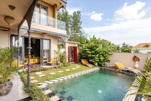 a swimming pool in the backyard of a house at Theatrical 4bd Villa Escapades with epic Rice Terraces Panoramas in Cemagi