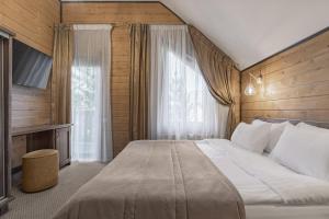 a bedroom with a large bed and a window at Bukovel Hotel in Bukovel +275 photos