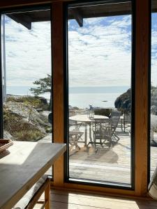 a room with a view of the ocean through a window at Original Architecture In Southern Norway in Søndeled