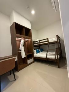 a room with two bunk beds and a desk at 1001 Nights Hotel, Trademark Collection by Wyndham in Genting Highlands