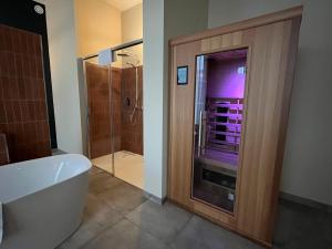 a bathroom with a shower and a tub and a toilet at Fletcher Hotel Paleis Stadhouderlijk Hof in Leeuwarden +84 photos