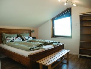 a bedroom with a large bed and a window at Das Vogelnest in Mössingen