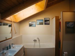 a bathroom with a tub and a sink at Das Vogelnest in Mössingen +34 photos