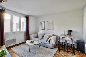 a living room with a couch and a table at Chaleureux T2 à 15 min de Lyon in Villeurbanne