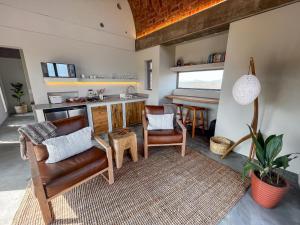 a living room with a couch and a table at Windvogels in Barrydale