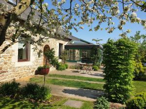 a stone house with a garden and a patio at Les Coquelicots classé 3 étoiles in Paimpol