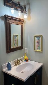 a bathroom with a white sink and a mirror at Rehoboth Beach Haven in Rehoboth Beach +41 photos