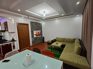 a living room with a couch and a table at APPARTEMENT "DINA" Kélibia in Kelibia