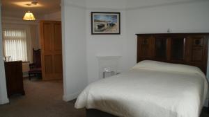a bedroom with a bed and a picture on the wall at Rockville in Cashel