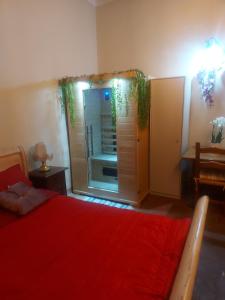 a bedroom with a red bed and a large window at QUERCECCHIO Relax in San Gimignano