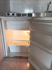 an empty refrigerator with its door open in a kitchen at Teo's 2 persons Studio Deluxe B2 in Patra