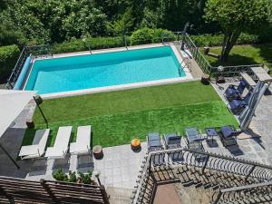 an overhead view of a swimming pool with chairs and a lawn at Blue emotion, into wellness & wilderness in Albano Laziale
