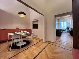 a dining room and living room with a table and chairs at Residenza DuLà in Arezzo
