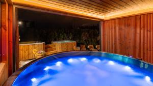 a large blue bath tub in a room at Villa Delta Boutique in Kościelisko +47 photos