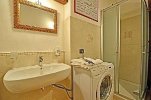 a bathroom with a sink and a washing machine at Podere Molinaccio in Panicale