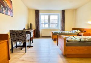 a room with a bed and a desk and a table at Hotelkamer voor twee personen op de begane grond 33-6 in Bunkenburg +7 photos