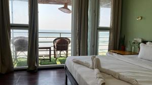 Ένα ή περισσότερα κρεβάτια σε δωμάτιο στο Sea Walk Beach Resort, Palolem, Canacona, Goa