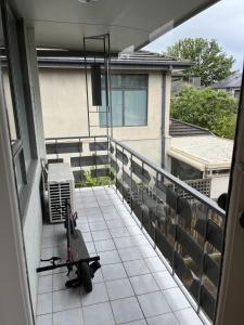 a balcony with a scooter parked on it at Private Cozy Room in a Spacious Flat in Carnegie in Carnegie