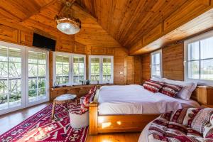 a bedroom with a large bed in a wooden house at The Animals Farm Double Room in Tirana