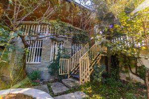 a house with a staircase in front of a building at The Animals Farm Double Room in Tirana