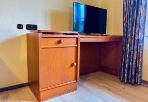 a wooden desk with a television on top of it at Hotelkamer voor twee personen op de begane grond 33-6 in Bunkenburg