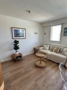 a living room with a couch and a table at Evasion en bord de Mer in Quiberon