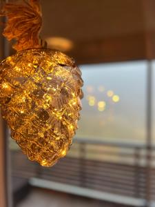 a chandelier with lights in front of a window at Stube9 am Feldberg, direkt an der Skipiste, Ski in-Ski out in Feldberg