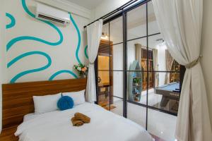 a teddy bear sitting on a bed in a bedroom at Villa De Doc Let Homestay in Nha Trang