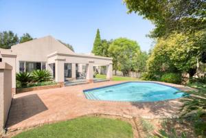 a swimming pool in the yard of a house at The Condor Nest! in Sandton