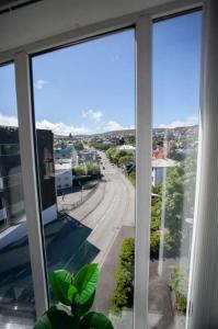 ein Fenster mit Blick auf eine Stadtstraße in der Unterkunft 3BR Modern Penthouse Apartment in the Heart of Torshavn in Tórshavn