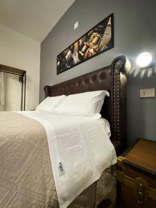 a bedroom with a large bed with white sheets at Maison Voyage Messina in Messina