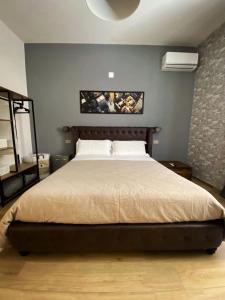 a bedroom with a large bed in a room at Maison Voyage Messina in Messina