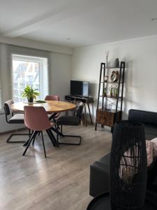 a living room with a wooden table and chairs at ChezPetitOscar in Middelkerke